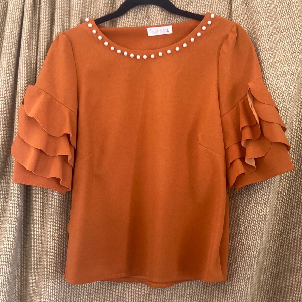 Orange Blouse with Ruffled Sleeves and Embellished Neckline